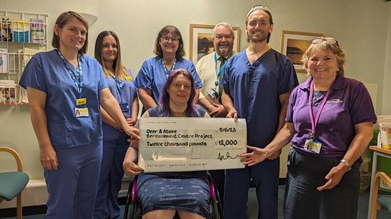 Image off Cllr. Helen Walker presenting cheque for £12,000 to membes of North Devon District Hospital Over-and-Above team.