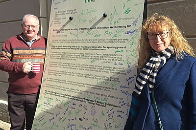 Ian Roome and Caroline Leaver with a giant letter in support of North Devon District Hospital