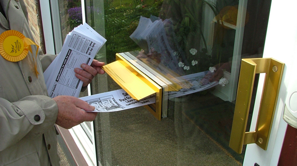 Volunteer delivering leaflets